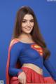 A woman in a superman costume posing for a picture.