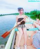 A woman sitting in a boat with a paddle.